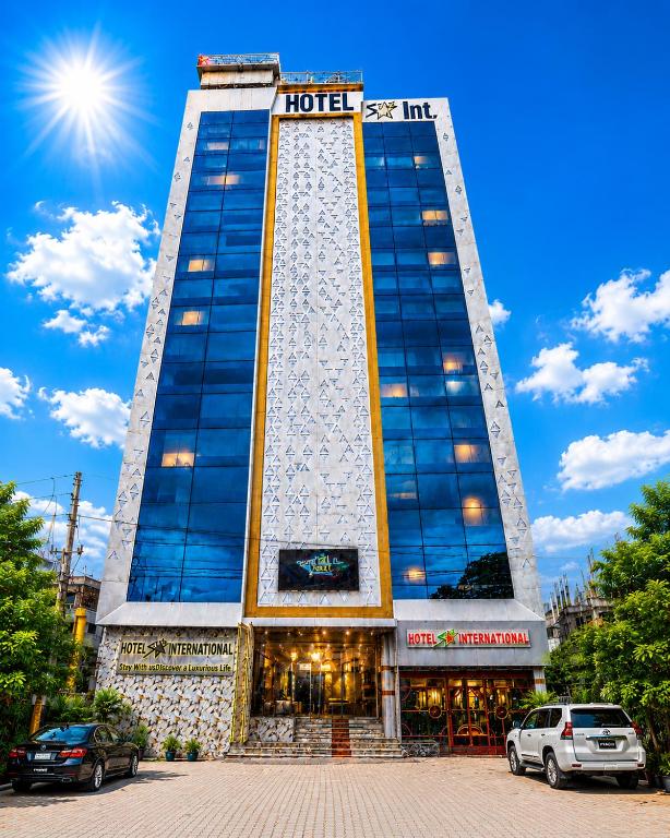 a hotel building with cars parked in front of it at Star International Rajshahi - Near Aam chattar in Rājshāhi
