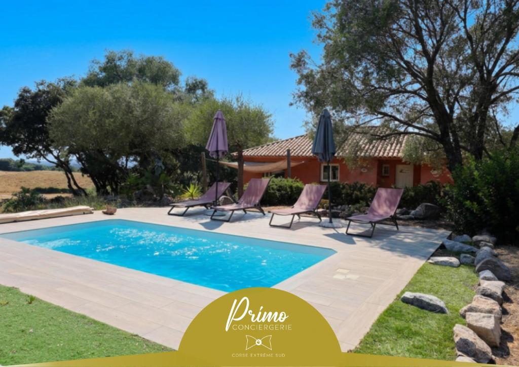 a pool with chairs and a house in the background at Villa A Liccia - Piscine & Vue Maquis - 8 Pers in Figari