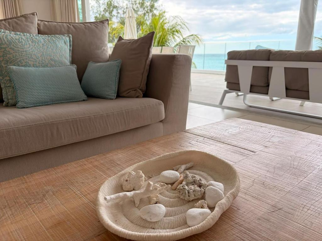 a baby crib in a living room with a couch at Beachfront Penthouse - Panoramic Ocean View in Cap Malheureux