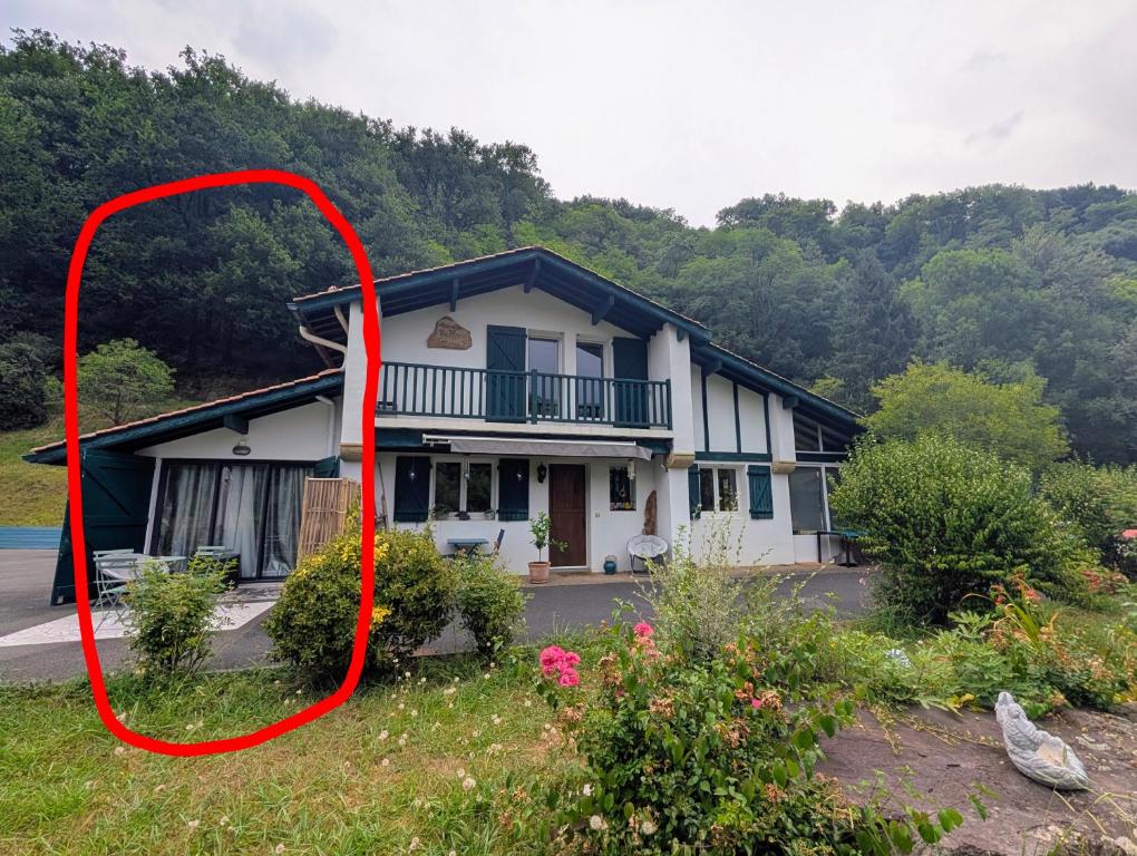 a house with a red frame in front of it at La maison d'Amatxi in Itxassou