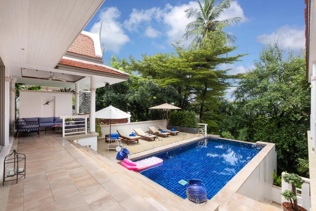 a swimming pool in a backyard with a house at Katamanda B2 Tropical Pool Villa Kata Beach in Kata Beach