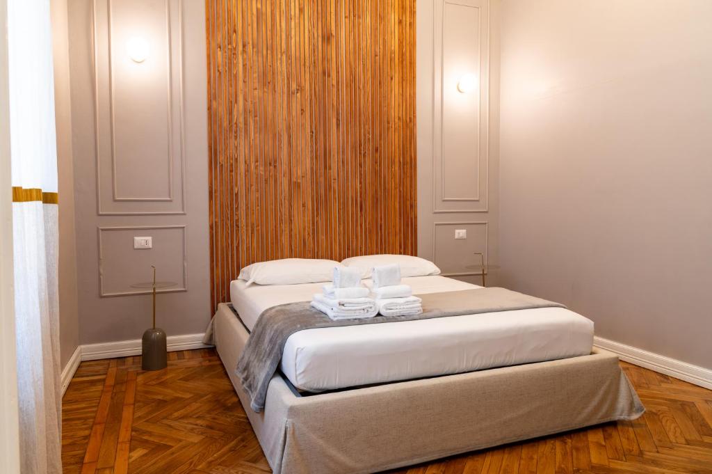 a bedroom with a bed with two towels on it at Turin Central Cavour in Turin