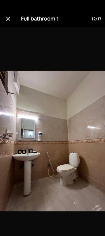 a bathroom with a toilet and a sink at CH guest house in Murree
