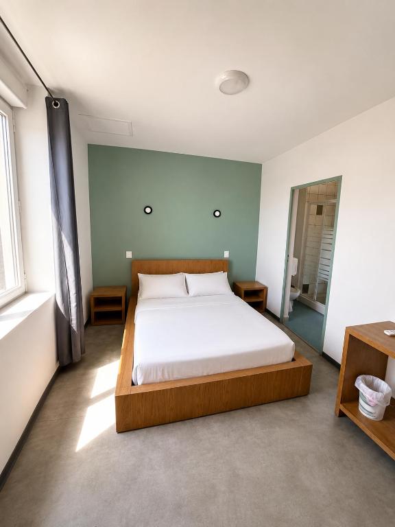 a bedroom with a large bed in a room at Hôtel 2 Étoiles centre ville in Mont-de-Marsan