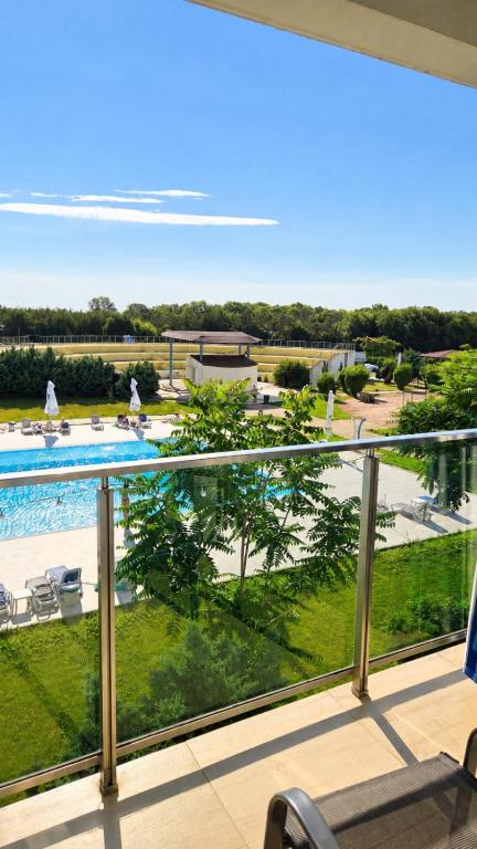 a view of the pool from the balcony of a resort at Zen Studio Olimp Poolside in Olimp