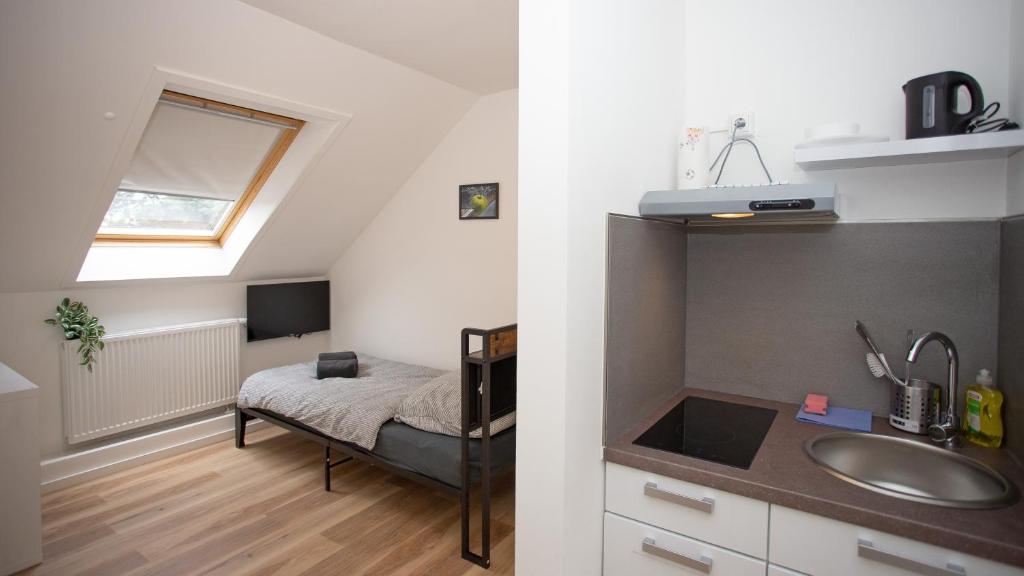 a bathroom with a sink and a bed in a room at Cesar Apartments in Wathlingen