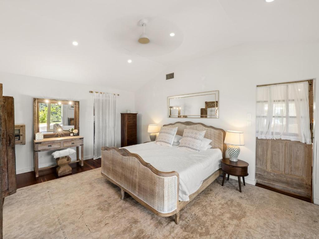 a bedroom with a large bed and a mirror at Fairview in Rosebank