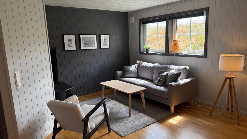 a living room with a couch and a table at Lemonsjøen, Jotunheimen in Vaga