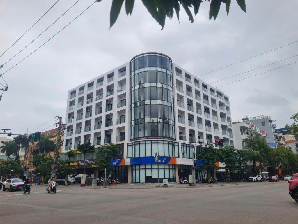 a large white building on a city street at Zen Central Hotel Bac Giang in Bắc Giang