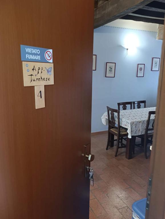 a door to a dining room with a sign on it at Agriturismo Aggazzotti in Colombaro