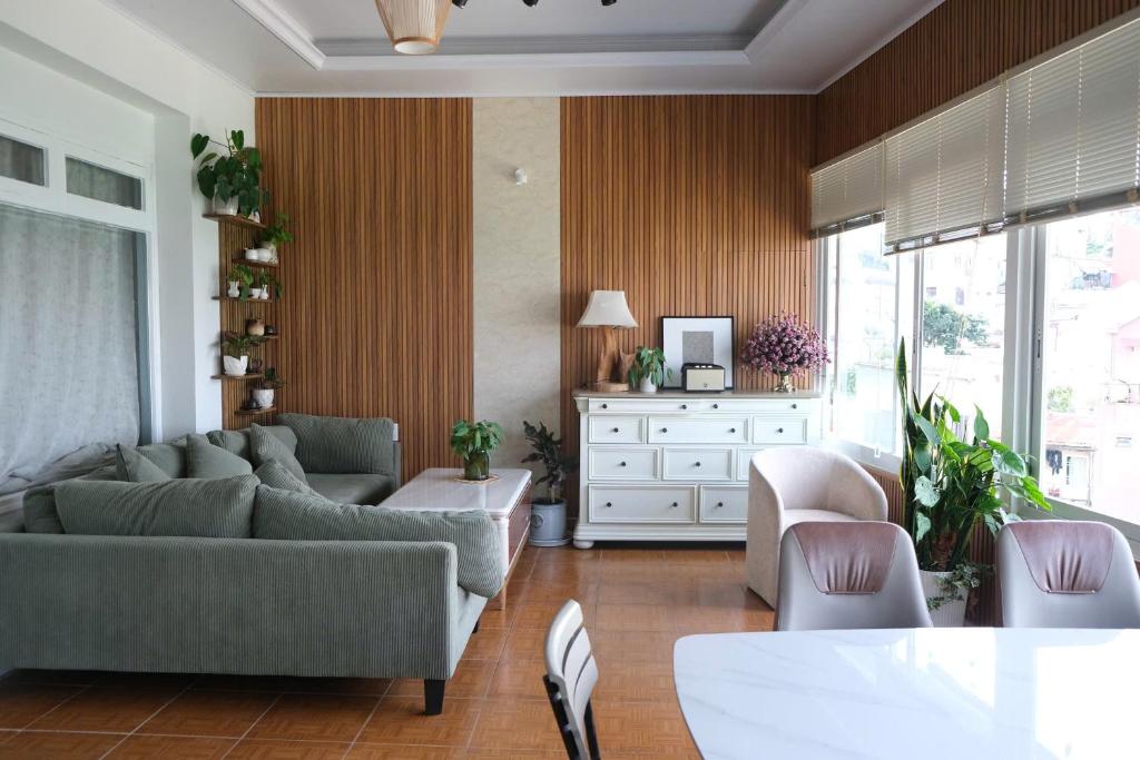 a living room with a couch and chairs and a table at Vanilla Homestay Da Lat in Da Lat