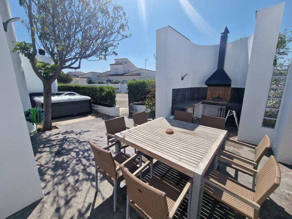 a wooden table and chairs on a patio at VILLA CALA LLARGA BEACH in Roses