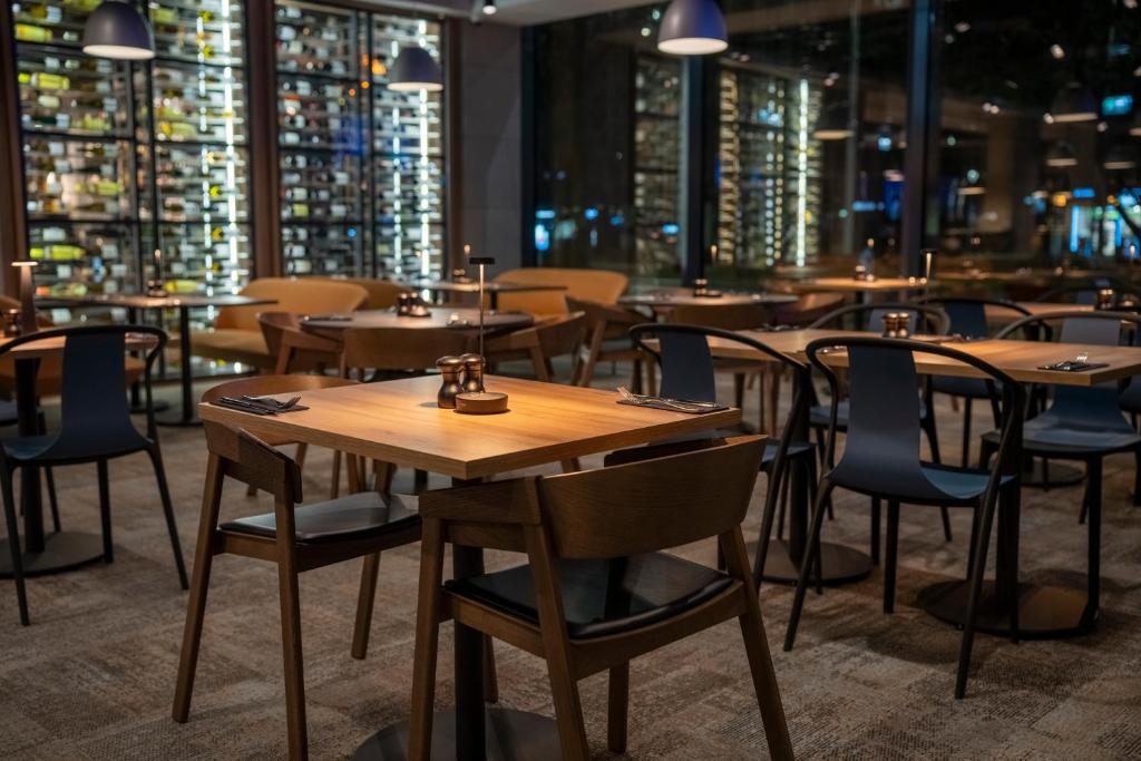 a row of tables and chairs in a restaurant at Q Hotel Plus Wrocław in Wrocław