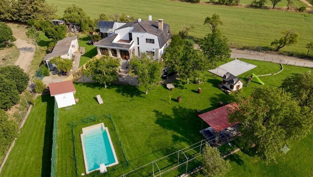 an aerial view of a large house with a swimming pool at Finca Alboroto in Huesca