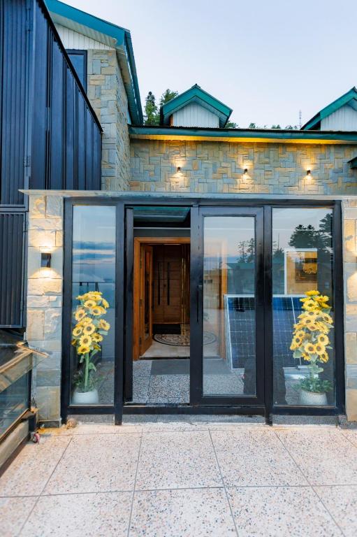 a house with sliding glass doors in front of it at ZAR Luxury Suites in Murree