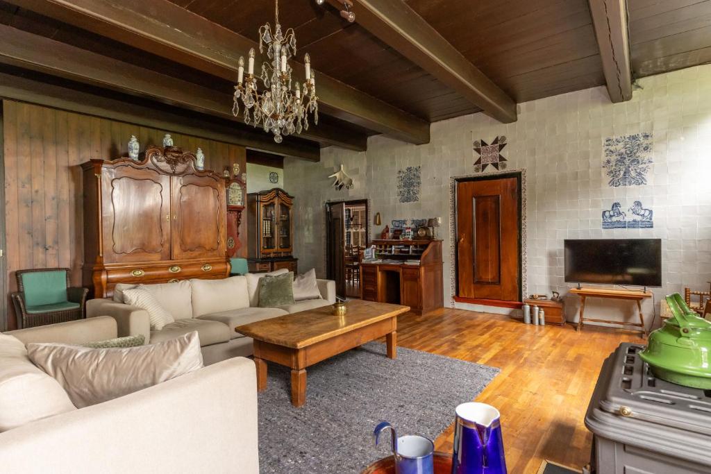 a living room with a couch and a table at De Boerstee in Ruinerwold