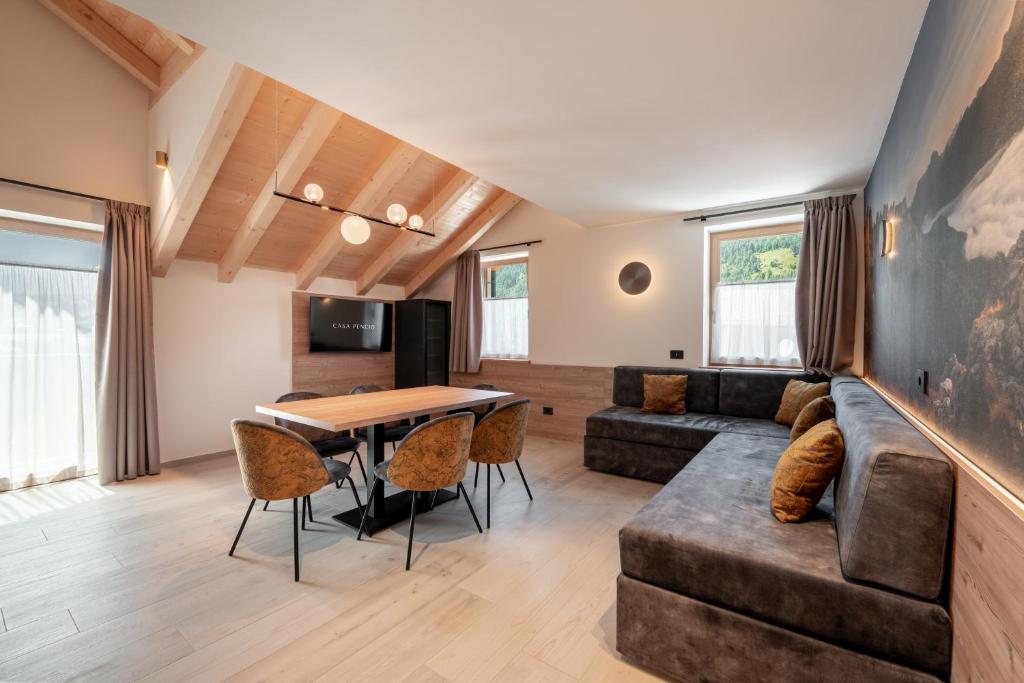 a living room with a couch and a table at Casa Pencio in Pozza di Fassa