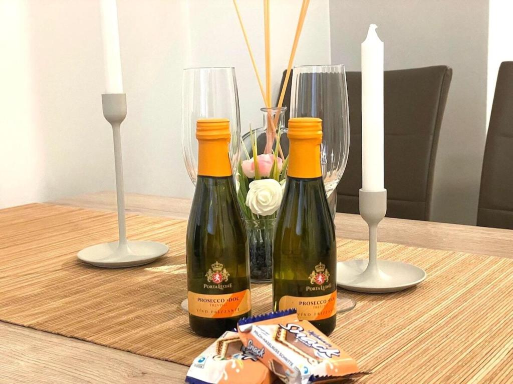 two bottles of wine sitting on a table with candles at Museums Quartier 0608 in Vienna
