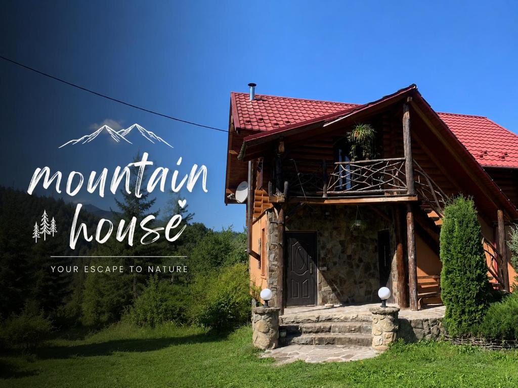 a mountain house with a sign that reads mountain house your escape to nature at Mountain House in Mykulychyn
