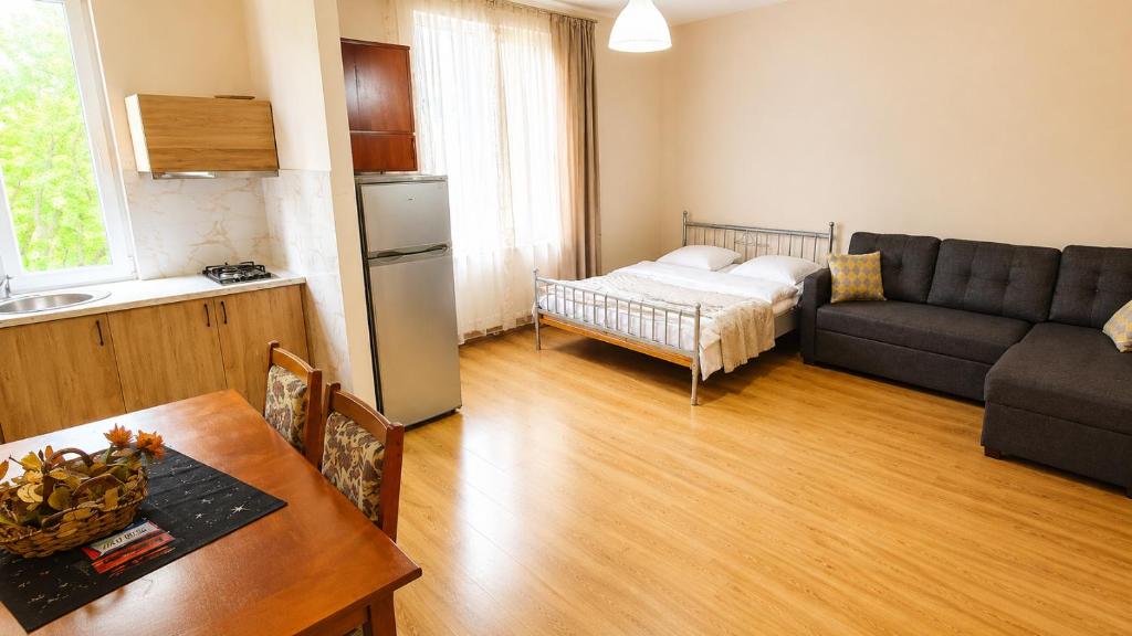 a living room with a couch and a table at Tuz House R6 in Bakuriani