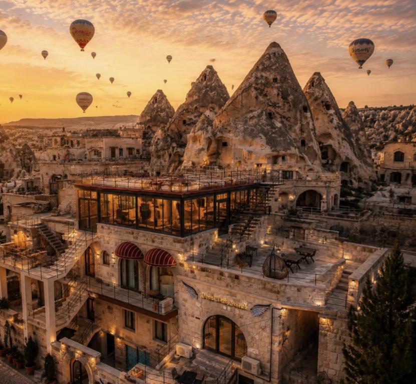 a group of hot air balloons flying over a city at Angel View Suites in Göreme