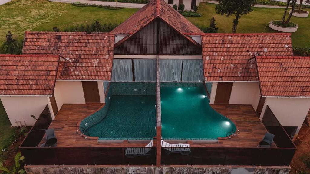 an aerial view of a house with a swimming pool at Mountain Vista Resort in Kalpetta