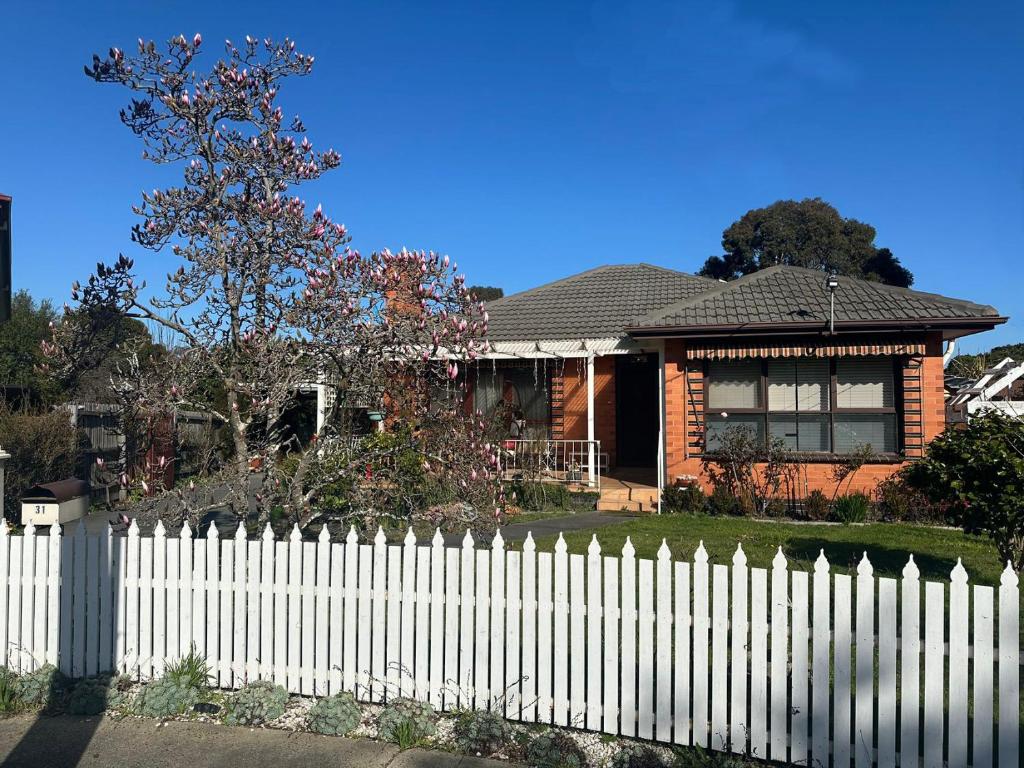 a white picket fence in front of a house at Jalynn homestay in Glen Waverley