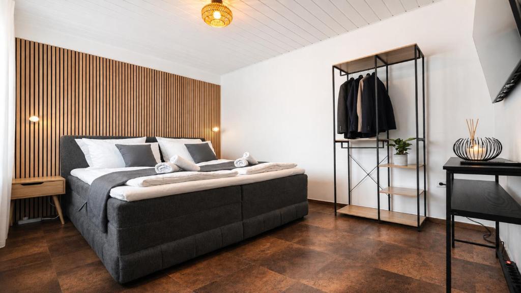 a bedroom with a large bed and a television at Wohnung für 4 Personen, 2 Schlafzimmer, Küche, Wlan in Großostheim