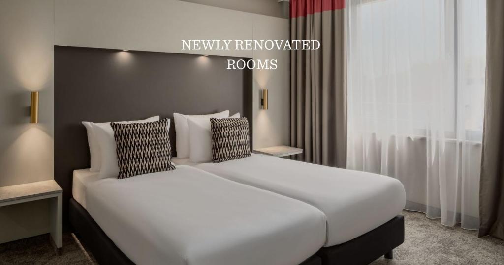 a bedroom with two beds in a room at Ramada by Wyndham Essen in Essen