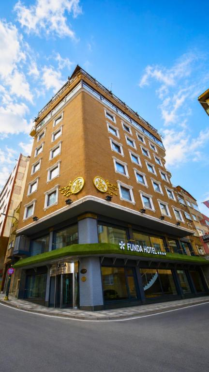 a building with a clock on the front of it at Funda Hotel in Trabzon