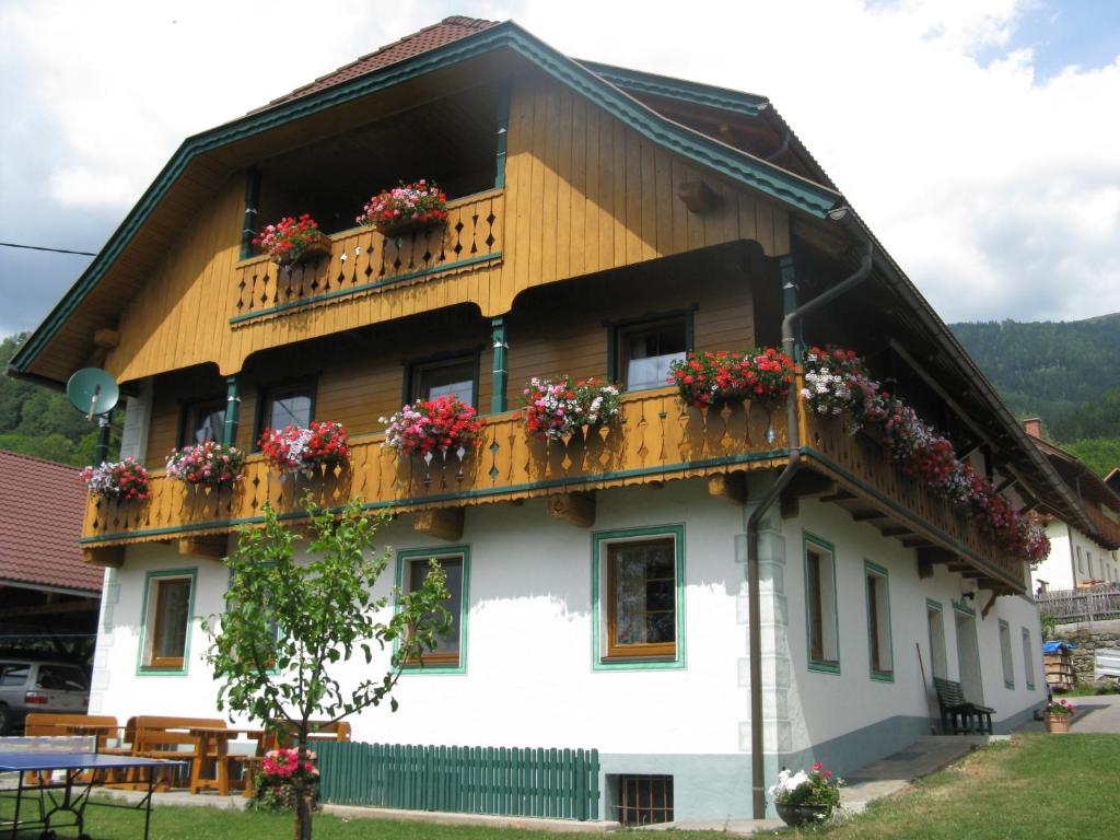 ein Haus mit Blumenkästen auf dem Balkon in der Unterkunft Ortnerhof in Millstatt