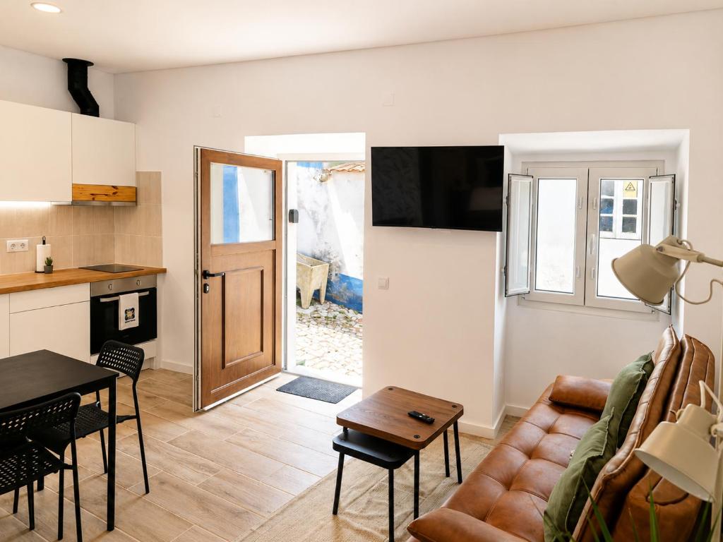 a living room with a couch and a table at Casa Nº9 - Vila d'Óbidos in Óbidos
