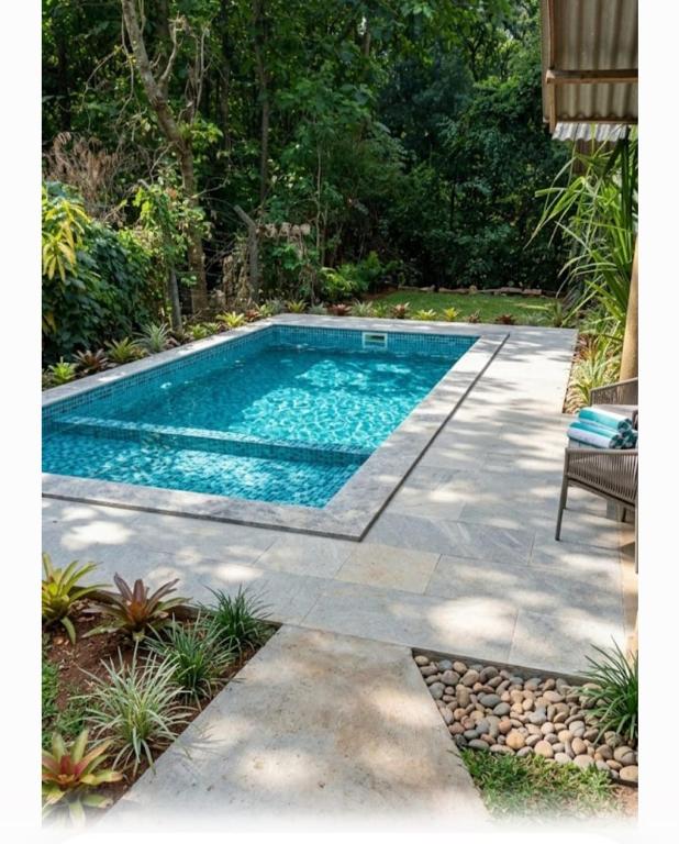 a swimming pool in the middle of a yard at Diamond Resorts in Udawalawe