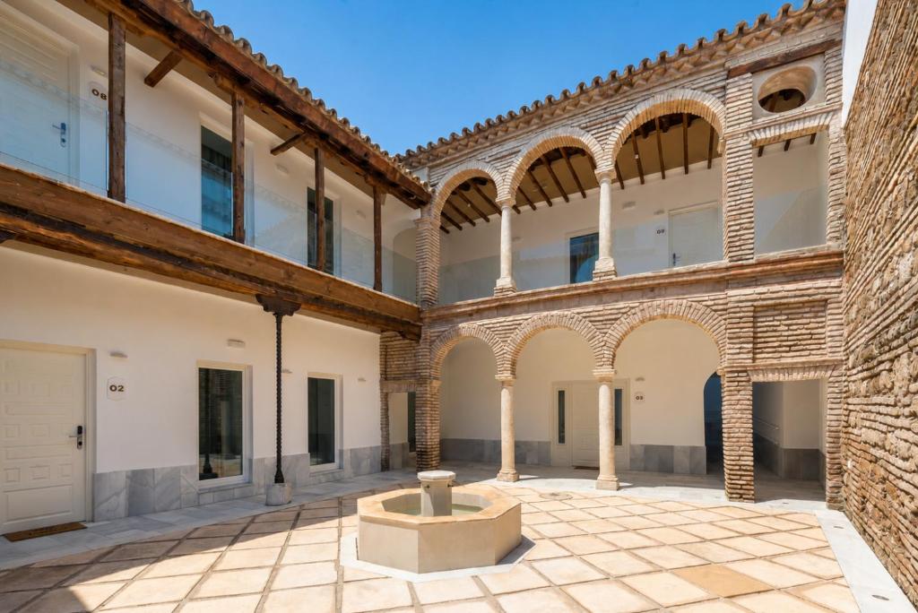 an empty courtyard in a building with arches at Tandem Mezquita in Córdoba