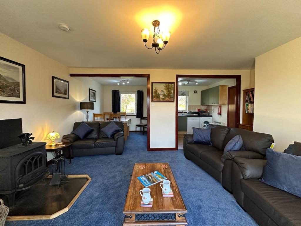 a living room with couches and a coffee table at Corrie View in Roybridge