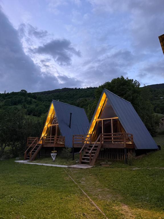 a house with a metal roof on a field at Larda in Nankvam-Zagrali