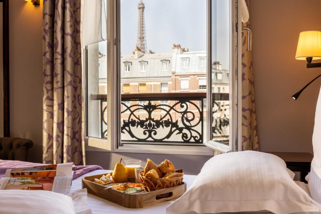 a hotel room with a view of the eiffel tower at Hôtel Le Relais Saint Charles in Paris