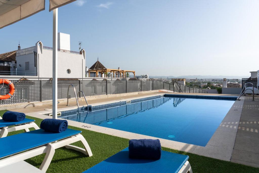 a swimming pool on top of a building at Hesperia Córdoba in Córdoba