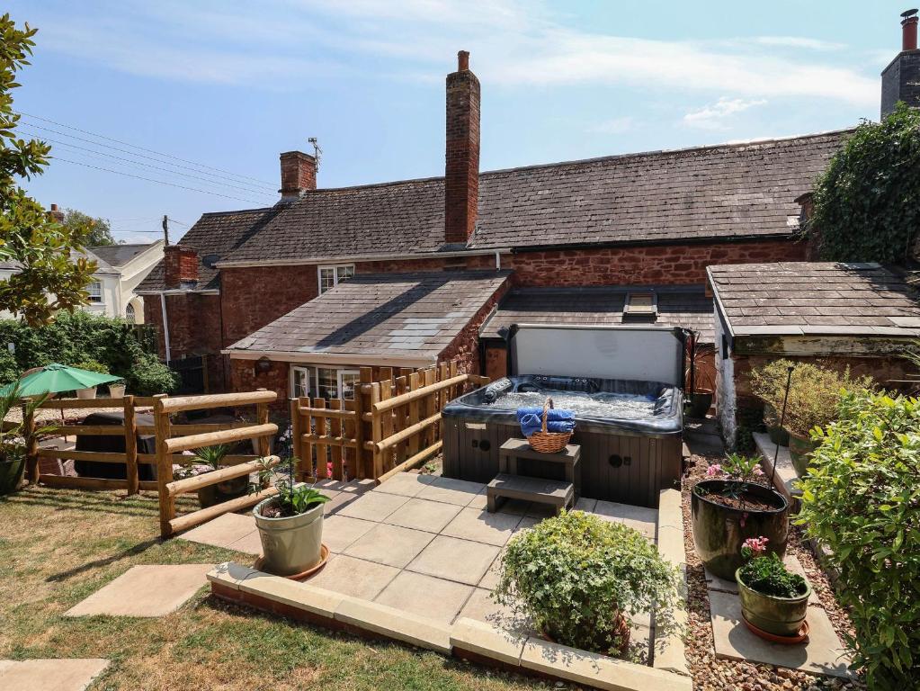 a backyard with a hot tub and a house at Pete's Place in Taunton