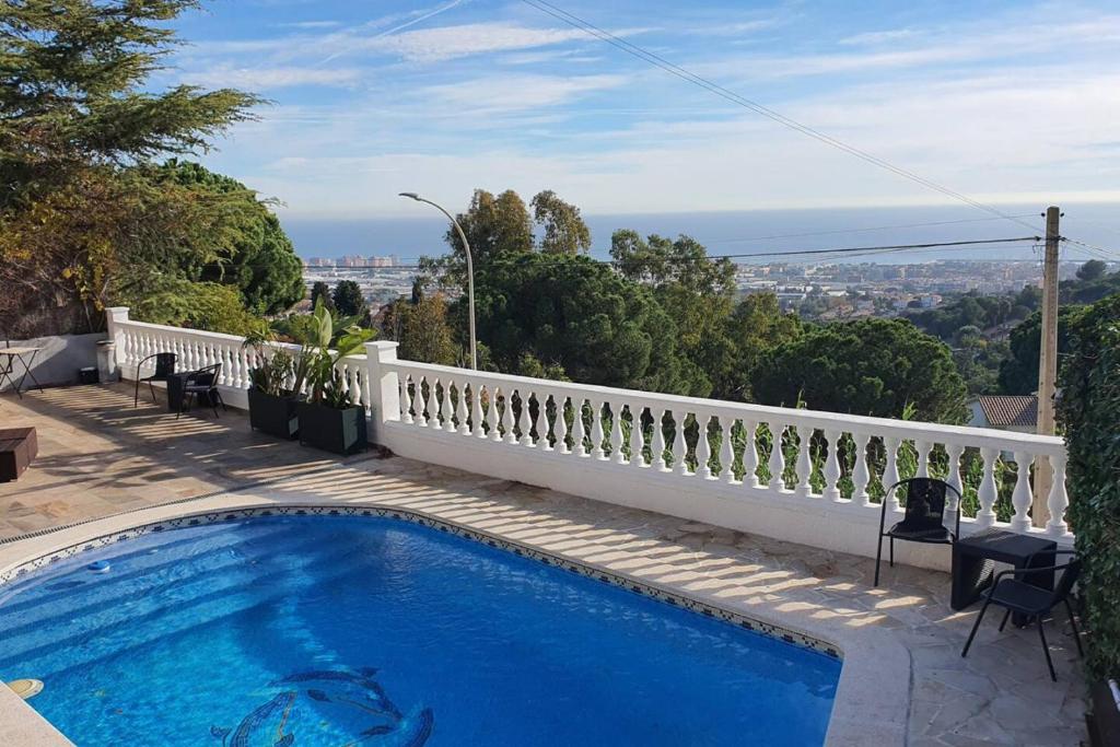 a swimming pool on the side of a house at Opening Doors Premiá Dalt Amazing views w pool in Premia de Dalt