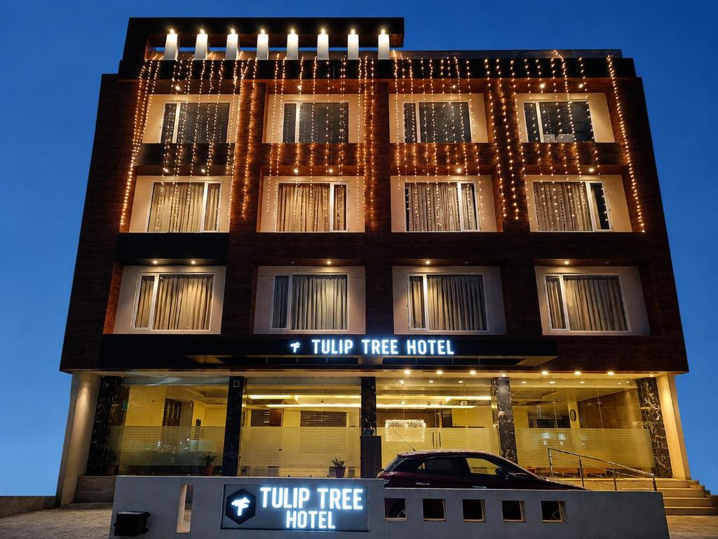a two tree hotel with a car in front of it at Tulip Tree Hotel in Katra