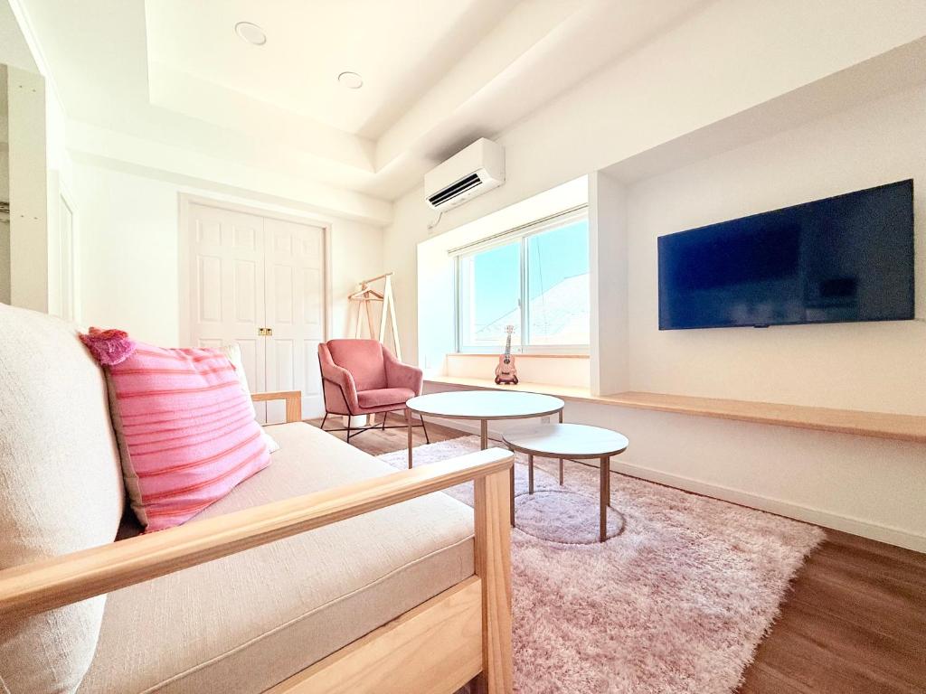 a living room with a couch and a tv at NEW OPEN! Villa Piesta in Atami