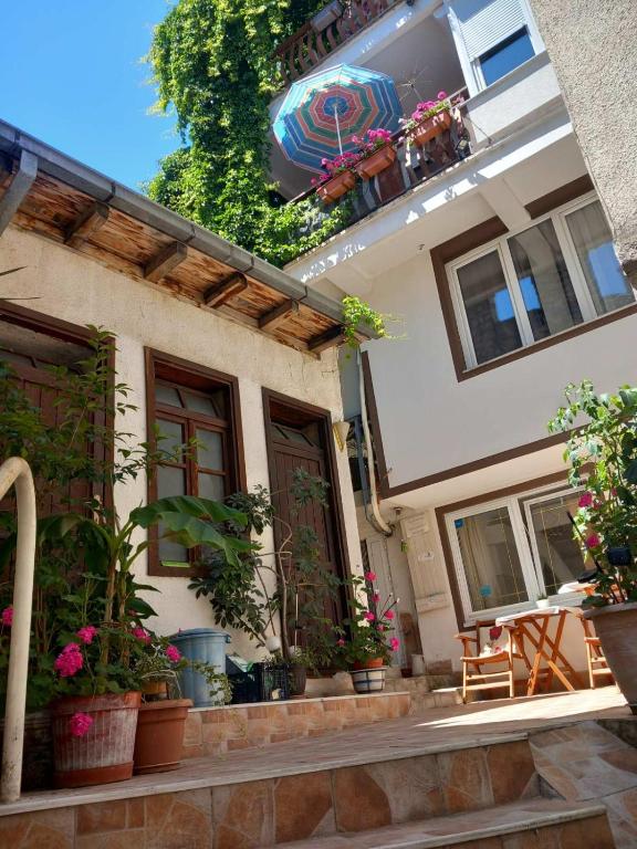 a building with potted plants on the side of it at Vila Kosta City Center Port in Ohrid