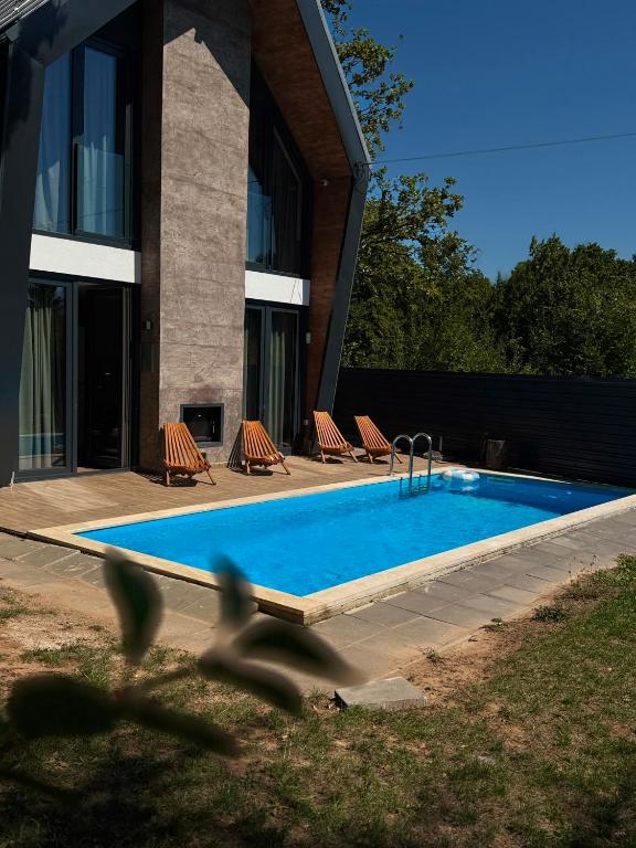 a swimming pool in front of a building at Orange Villa with private pool in Ilidža