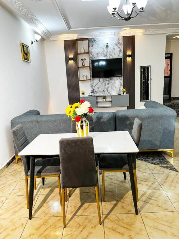 a living room with a couch and a table at Maridel Home in Yaoundé