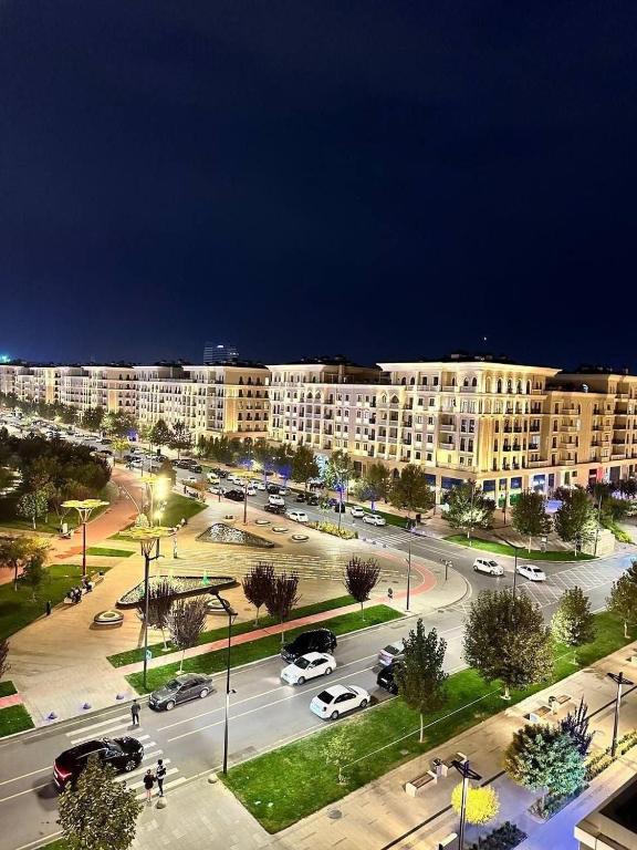 a large building with a parking lot in front of it at Gardence Residence Suite in Tashkent