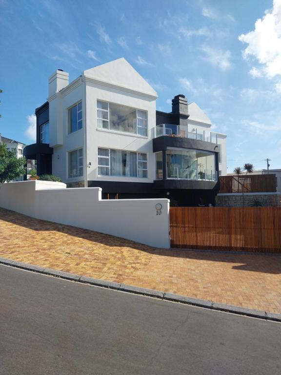 a large white house on the side of a street at Ocean View living in Hermanus