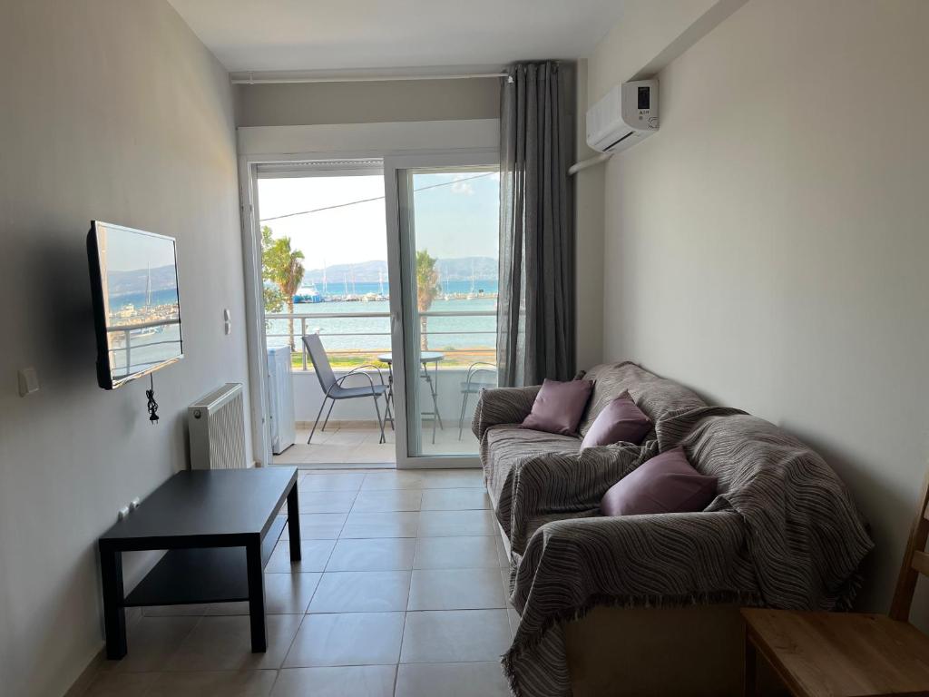 a living room with a couch and a table at Thalassa View VB2 in Khalkoútsion