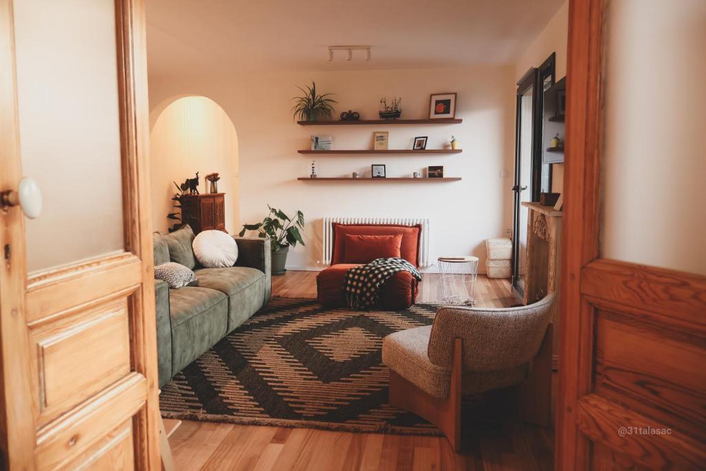 a living room with a couch and a chair at Alazne Enea in Bermeo