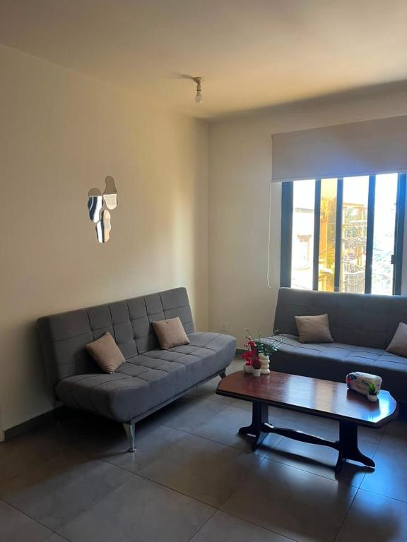 a living room with a couch and a coffee table at Étoile Batroun in Batroûn